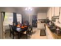 Eat-in kitchen with table and chairs, and ample cabinetry at 11221 Lake Eustis Dr, Leesburg, FL 34788