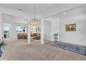 Bright living room with a chandelier and comfortable seating at 12592 Se 97Th Terrace Rd, Summerfield, FL 34491