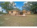 House exterior showcasing a well-maintained lawn and landscaping at 13588 Sw 105Th Pl, Dunnellon, FL 34432