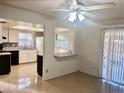 Bright dining area with view into kitchen and access to patio at 13635 Berkshire Ct, Grand Island, FL 32735