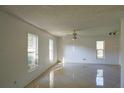 Bright living room featuring tile floors and multiple windows at 13635 Berkshire Ct, Grand Island, FL 32735