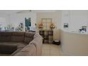 Living room with sectional sofa and decorative shelving at 137 Country Lakes Cir, Groveland, FL 34736