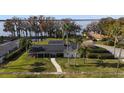 House with lake view, lush lawn, and palm trees at 1401 Lake Shore Blvd, Tavares, FL 32778