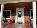 Front entrance with brick columns, tile flooring, and decorative planters at 1401 Lake Shore Blvd, Tavares, FL 32778