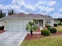 Single-story house with a two-car garage and nicely landscaped yard at 14267 Se 85Th Ter, Summerfield, FL 34491