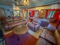 Living room with leather furniture and a view into another living area at 1503 Woodlyn Dr, Leesburg, FL 34748