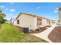 Neat side yard with a path and landscaping, AC unit visible at 1526 Lozano Ave, Lady Lake, FL 32159