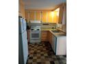 Bright kitchen with orange cabinets and checkered floor at 164 Jacaranda Dr, Leesburg, FL 34748