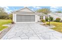 Two-car garage with a screened enclosure and a flagstone driveway at 2123 Barbosa Ct, The Villages, FL 32159