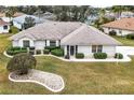 Single-story home with landscaped yard and driveway, viewed from above at 21721 Loch Haven Pass, Leesburg, FL 34748