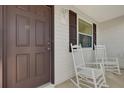 Front porch with two rocking chairs at 2214 Quinn Ln, The Villages, FL 32162