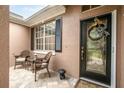 Inviting front porch with wicker chairs and a charming wreath at 2334 Fenton Ave, Clermont, FL 34711