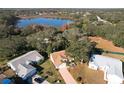 Aerial view of a house near a lake in a quiet residential neighborhood at 25107 Meriweather Rd, Leesburg, FL 34748