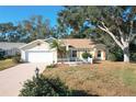 Front view of charming house with a white picket fence and lush lawn at 25107 Meriweather Rd, Leesburg, FL 34748