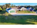 House with driveway and landscaping, viewed from above at 25339 Hibiscus St, Leesburg, FL 34748