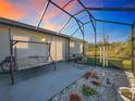 Relaxing screened patio with seating and garden area at 25339 Hibiscus St, Leesburg, FL 34748