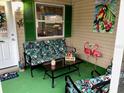 Relaxing screened porch with tropical decor and seating at 2552 Mariel Way, The Villages, FL 32162