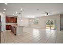 Open concept kitchen with island, stainless steel appliances, and dark wood cabinets at 29567 Caspian St, Leesburg, FL 34748