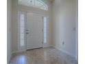 Bright entryway with tiled floors and a white front door at 3144 Blackstock Way, The Villages, FL 32163