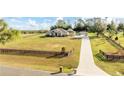 House with long driveway and expansive fenced yard at 41516 Saddle Ridge Ln, Weirsdale, FL 32195