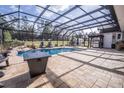 Enclosed pool area with patio and outdoor kitchen at 41516 Saddle Ridge Ln, Weirsdale, FL 32195