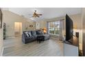 Living room featuring a comfortable sectional sofa and a TV at 438 Woodview Dr, Tavares, FL 32778