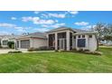 One story home with three-car garage, screened porch, and nicely landscaped yard at 4928 Kelso St, Leesburg, FL 34748