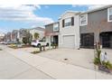 Townhome with an attached garage and concrete driveway enhanced by manicured landscaping at 5278 Dragonfly Dr, Wildwood, FL 34785