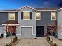 Charming townhome featuring an attached garage, neutral-toned exterior, and thoughtfully landscaped front yard at 5278 Dragonfly Dr, Wildwood, FL 34785