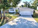 Front yard view of a newly remodeled home with driveway at 808 E Orange St, Apopka, FL 32703