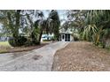 Home exterior showcasing a carport and lush landscaping at 819 Edgewater Dr, Eustis, FL 32726