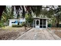 Quaint house with a screened porch and a well-manicured lawn at 819 Edgewater Dr, Eustis, FL 32726