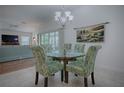 Charming dining area with glass-top table and patterned chairs at 963 Hart Dr, The Villages, FL 32163