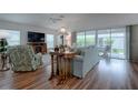 Spacious living room featuring hardwood floors and access to a lanai at 963 Hart Dr, The Villages, FL 32163