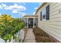 Inviting front entry with a white picket fence and walkway at 1007 Dustin Dr, The Villages, FL 32159