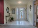 Bright and airy entryway with tiled floor and stained glass door at 12327 Se 92Nd Court Rd, Summerfield, FL 34491