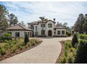 Two-story home with tile roof, driveway, and landscaping at 15118 Pendio Dr, Bella Collina, FL 34756