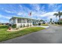 Quaint manufactured home with mature landscaping and driveway at 16 Captains Pt, Fruitland Park, FL 34731