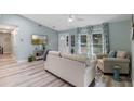Living room with light walls, a neutral couch, and a view of the backyard at 1660 1St St, Clermont, FL 34711