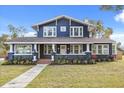 Renovated two-story home with a welcoming front porch and well-manicured lawn at 2001 Sanford Ave, Sanford, FL 32771