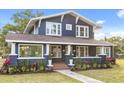 Two-story home features a large front porch and beautifully landscaped yard at 2001 Sanford Ave, Sanford, FL 32771