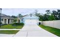 Cute blue house with a two-car garage and a landscaped front yard at 2295 Delhi Pl, Sanford, FL 32771