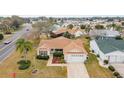 Single-story house with a driveway and yard, seen from above at 3200 Woodridge Dr, The Villages, FL 32162