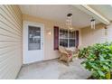 Cozy front porch with rocking chairs and potted plants at 3200 Woodridge Dr, The Villages, FL 32162