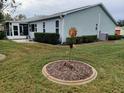 Rear view of house showing additional windows and patio at 32218 Sweet Briar Court, Leesburg, FL 34748