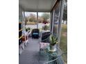 Relaxing screened porch with wicker furniture and plants at 32218 Sweet Briar Court, Leesburg, FL 34748