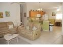 Open kitchen with oak cabinets, gas stove, and breakfast bar at 3243 Mansfield St, The Villages, FL 32162