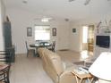 Bright living room with tile floors, recliner, and dining area at 3243 Mansfield St, The Villages, FL 32162