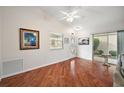 Living room with hardwood floors, access to patio, and ceiling fan at 3347 Empire Ave, The Villages, FL 32163