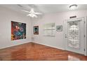 Bright and airy living room with hardwood floors and large artwork at 3347 Empire Ave, The Villages, FL 32163